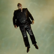 Chiwetel Ejiofor's Farady floats in a pool while still wearing a full suit, in a scene from The Man Who Fell to Earth.